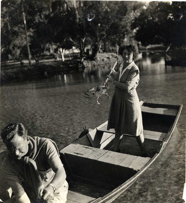 Marjorie Kinnan Rawlings standing in a rowboat and crabbing at Salt Springs