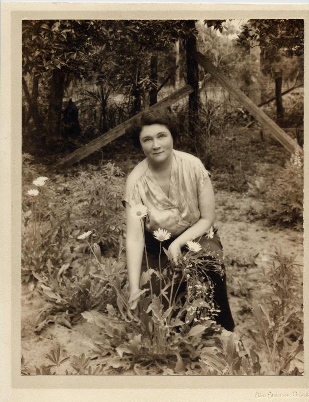Marjorie Kinnan Rawlings kneeling in her garden at home in Cross Creek in 1930s