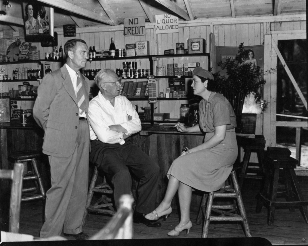 Two men speaking with Marjorie Kinnan Rawlings